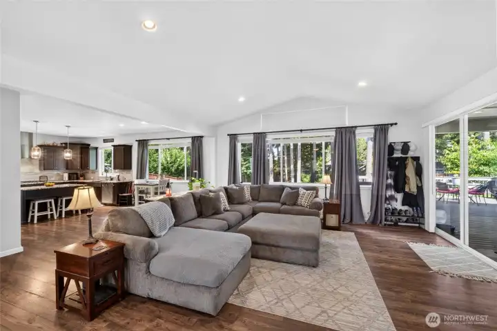 Large picture windows and sliding doors bring the outdoors in while creating a bright and inviting central gathering space.