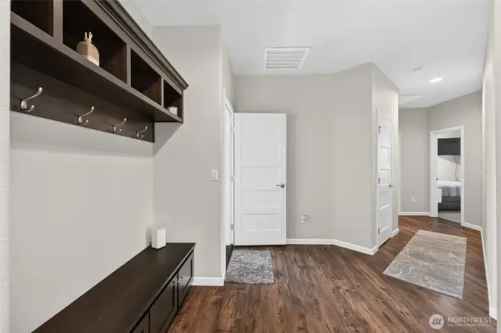 Thoughtfully designed mudroom area features built-in bench seating, storage, and organization for everyday living.