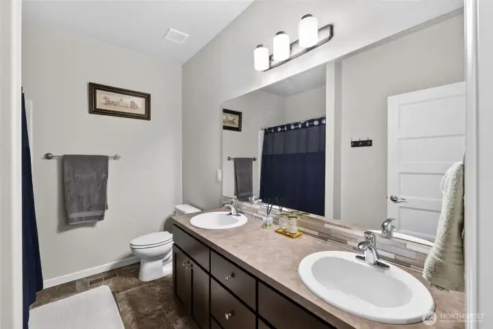 Spacious bathroom with double sinks and ample counter space makes busy mornings a breeze.