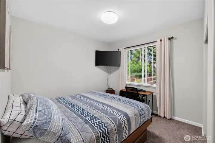 Bright and inviting bedroom offers flexibility for guests or a home office.