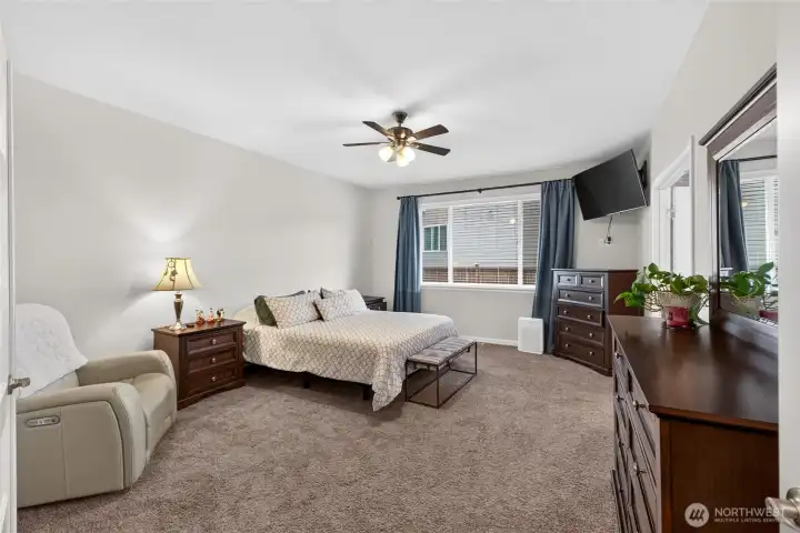 Generously sized primary suite provides ample space for a sitting area and creates a relaxing private retreat.