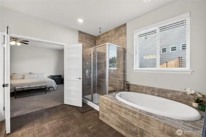 Unwind in the soaking tub or enjoy the oversized walk-in shower in this beautifully appointed primary ensuite.