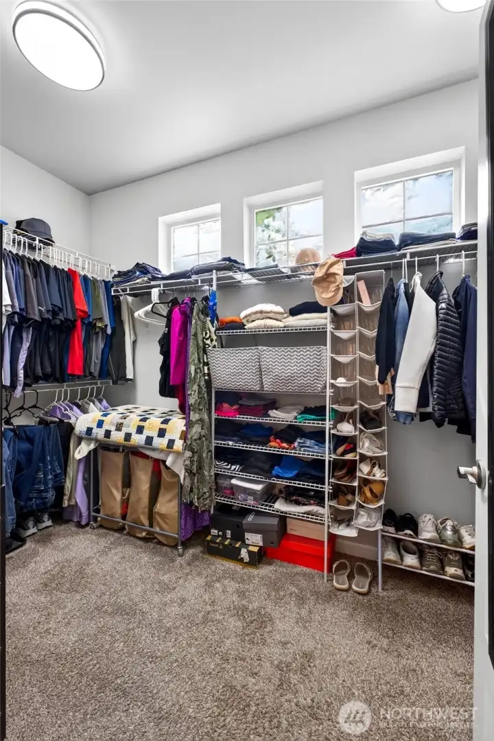 Large walk-in closet offers exceptional storage, organization, and room for an extensive wardrobe.
