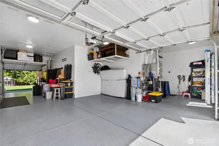 Oversized three-car garage offers abundant room for vehicles, storage, hobbies, and workshop space.