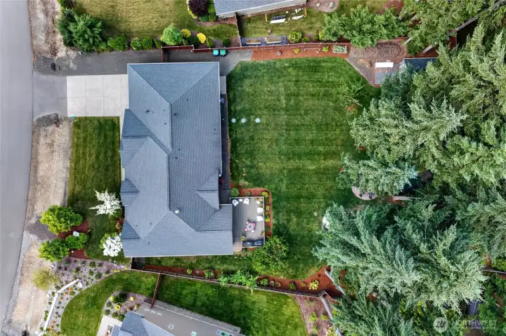 Expansive backyard offers room to play, entertain, garden, and enjoy the peaceful natural setting.
