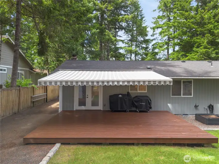Backyard with awning out - perfect to enjoy the summer days with shade