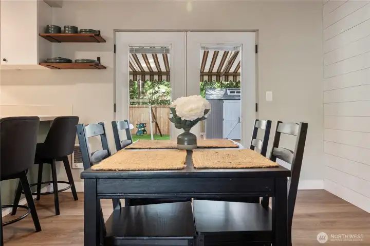 Dining room with french doors leading you out to the fully fenced yard.