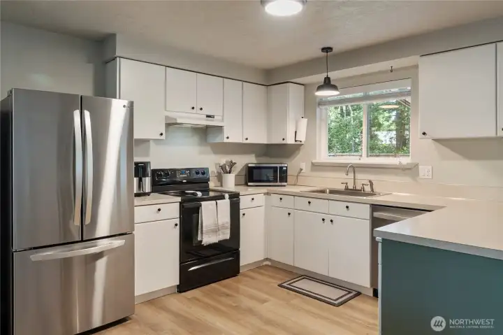 Kitchen looks to the backyard.