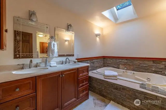 Primary suite bathroom has a large tub for a maximum relaxation.