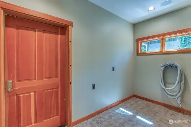 The large pantry room is located just off of the attached garage and perfect for stocking. before entering the main living area. There is an installed vacuum system through out the home.