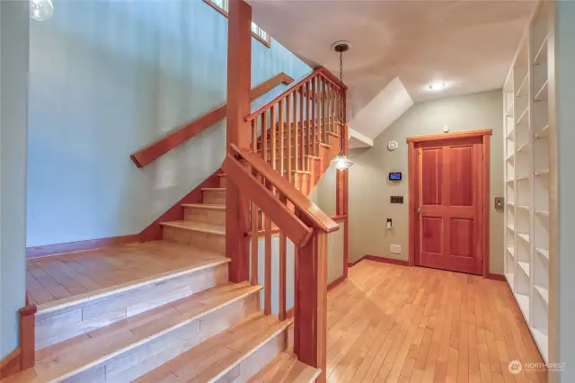 The main entry brings you to a transition area where you can use the stairs or use the elevator  to acces all three level of the home.