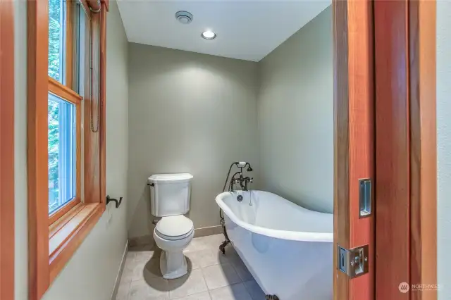 Soak in the tub in privacy while you enjoy the forest view.