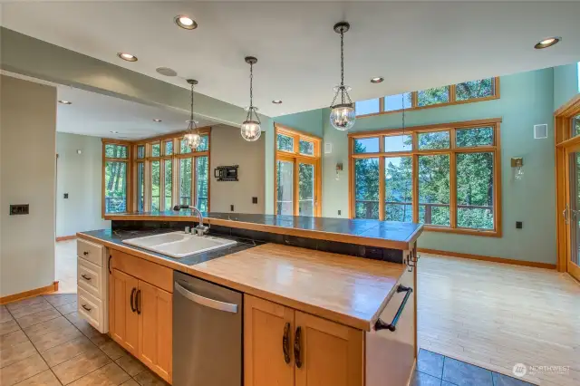 The kitchen overlooks a dining and sitting area for s social setting.