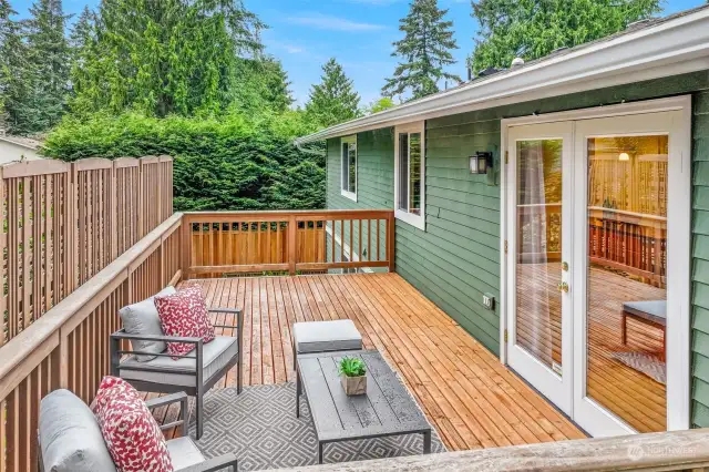 Spacious and private back deck with ample room for seating and outdoor furniture.