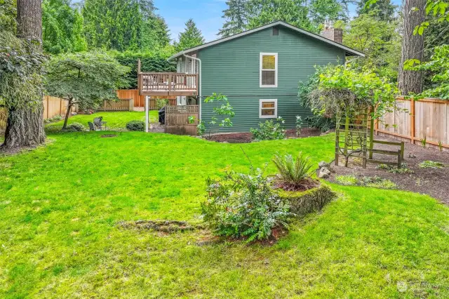 The massive, newly fenced back yard with entertainment sized deck, covered patio off the family room, and lush privacy plantings create an abundance of space to garden, entertain or play!