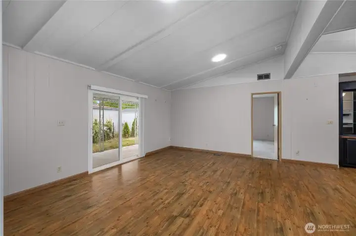 Slider to covered awning directly off living room, primary bedroom is straight ahead. Note the newly installed skylight suntunnels which brighten up the space!