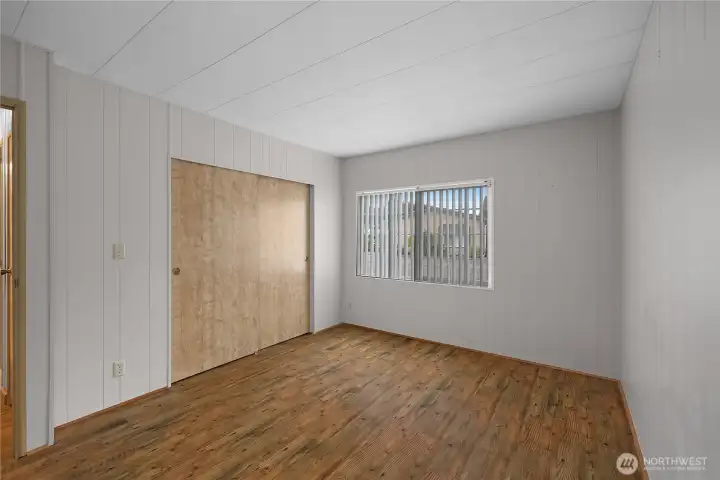 Vacant view of first bedroom on opposite wing of home.