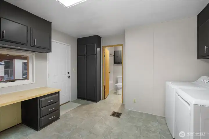 Alternate view of laundry space looking into guest bathroom - door to left leads to covered carport for easy access!
