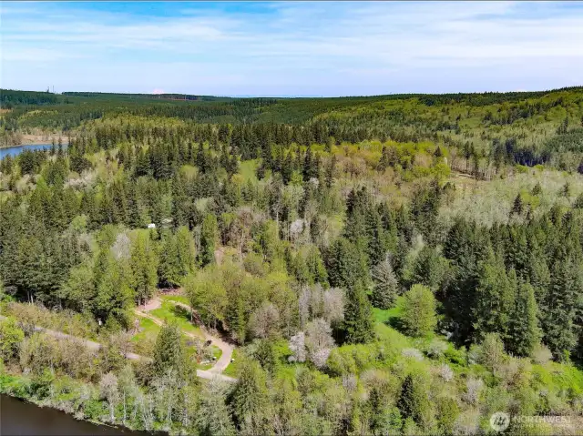 View of the driveway to the property with the open homesite with lake view.