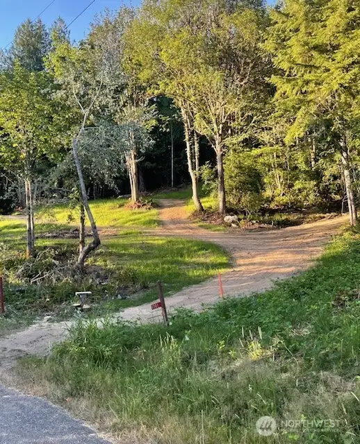 Entrance off paved road with power nearby.
