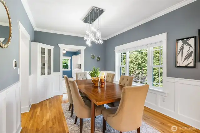 Refurbished trim, board and batten wainscoting, crown molding and a corner built-in highlight the craftsman architecture.