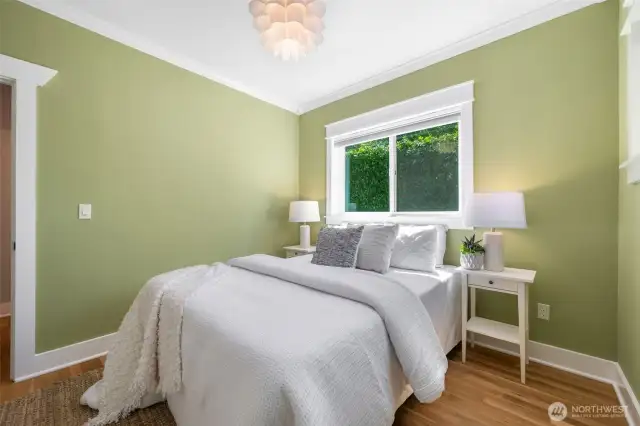 The larger bedroom upstairs with 2 windows and a double closet. This is a queen with 2 side tables.
