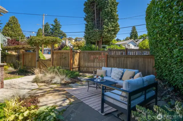 There is a concrete platform by the fence that was poured for a BBQ space.