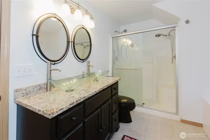 Primary bath with dual sink vanity, large shower, and separate tub.