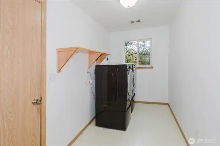 Laundry room with shelving.