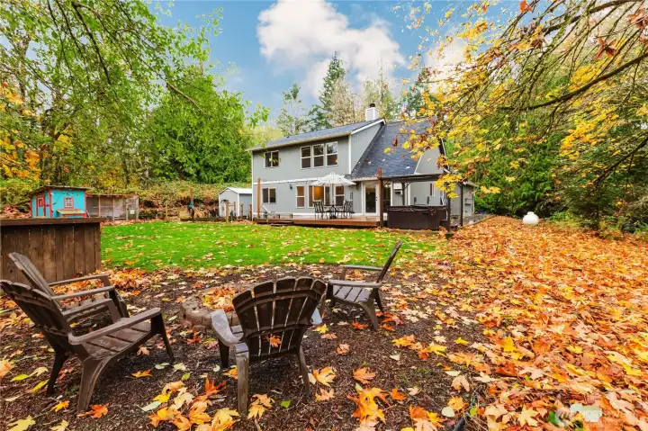 Inviting outdoor spaces include a firepit area.