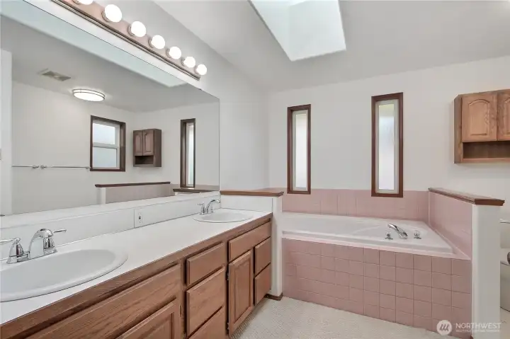 Primary Suite bath, true 5-piece with double vanity, soaking tub and separate shower. Cathedral ceilings and skylight, an oasis!