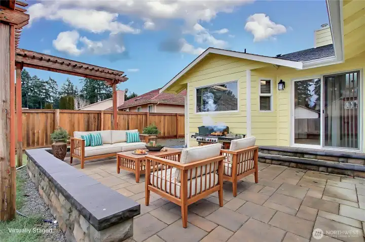 Backyard patio view, love the NEW professionally installed pavers, the pergola and the large patio doors leading from your kitchen/dining area. ***Virtually Staged***