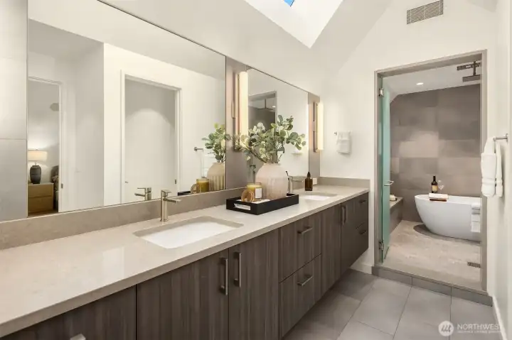 Spa inspired Primary bath with dual sinks and "wet room" design.  Large soaking tub and built in bench.