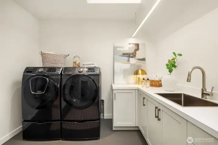 Upper level laundry.  Large space with built ins and utility sink.