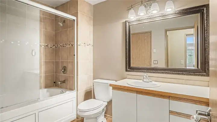 Main bathroom with ample counterspace and neutral color palate.