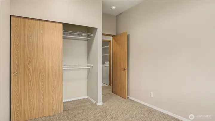 Cozy guest bedroom featuring a sliding door closet for convenient storage and a welcoming retreat for visitors.