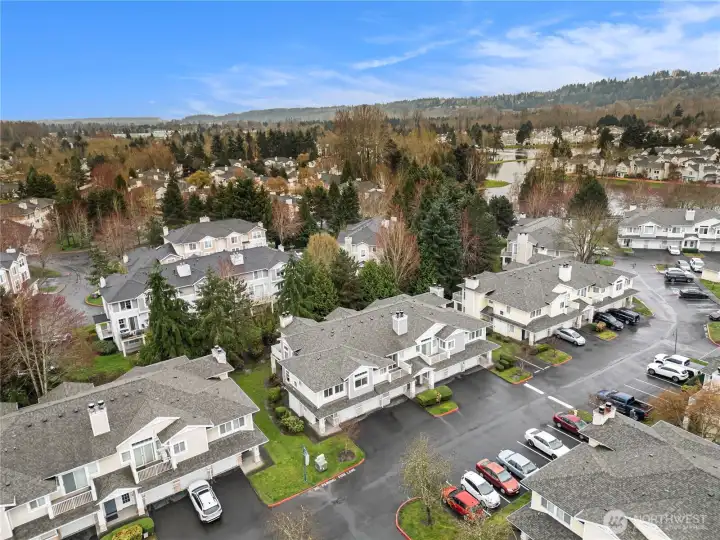 Complex is surrounded by plenty of tall trees and greenery.