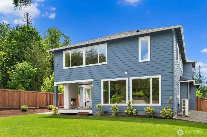 Positioned on a prominent corner lot, the home is framed by freshly refreshed landscaping, mature privacy plantings, and thoughtfully curated garden spaces that enhance both curb appeal and outdoor livability.