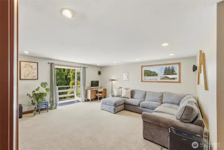 Upstairs family room with french doors in the background leading to small viewing deck. Upstairs family room with french doors in the background leading to small viewing deck.