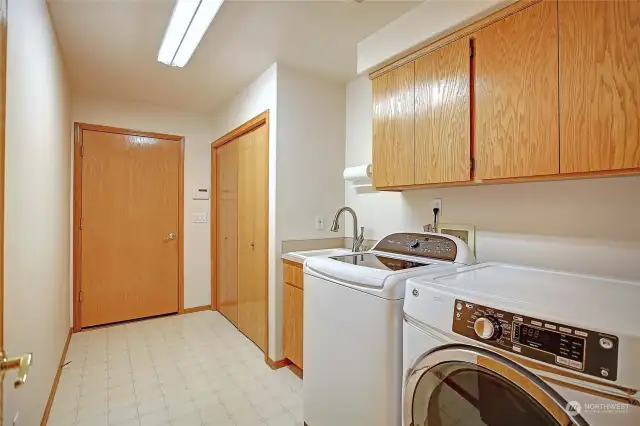 The main floor laundry with extra storage/pantry is super handy as you enter from the garage.