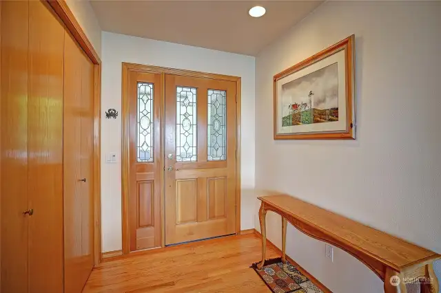 The spacious foyer with large closet. Note the solid oak flooring in pristine shape!