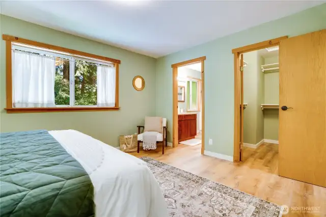 Main floor primary suite also includes walk-in closet and en suite bath.