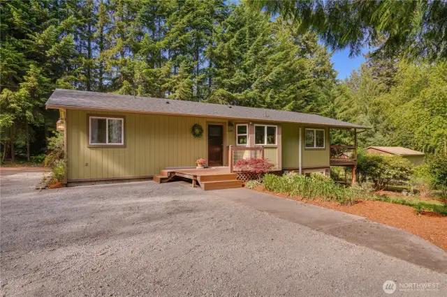 Welcome home to your peaceful forest retreat—charming curb appeal, new roof, and an inviting front deck nestled in nature.