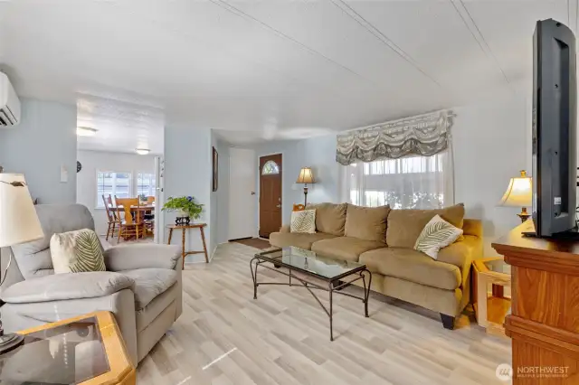 Living room is open and bright, coat closet as you enter