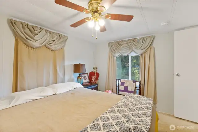 Primary bedroom has 2 good size windows and ceiling fan