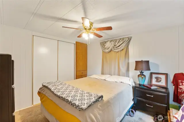 Primary bedroom has large closet and built in cabinet and drawers