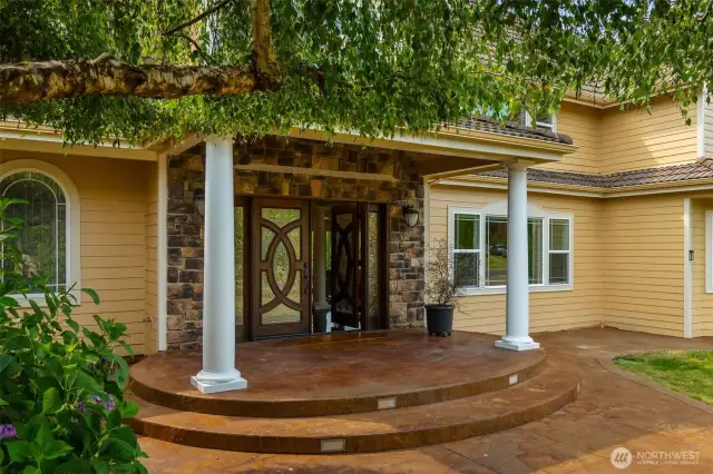 Stamped concrete walkways invite you in to the gracious property