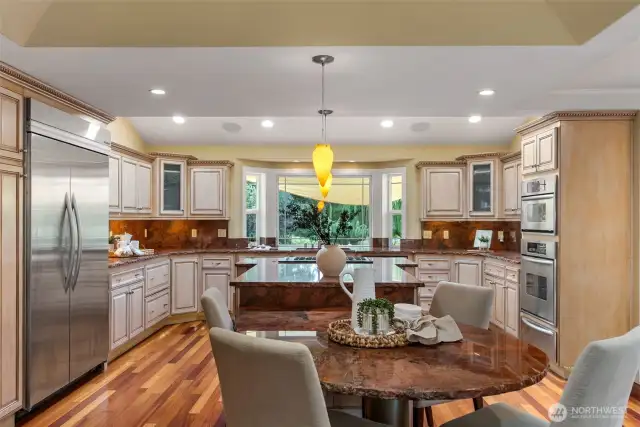 Chiseled edge granite, built-in fridge/freezer, wall oven/micro, dbl drawer dishwasher, gas cooktop w/downdraft, wine cooler and custom cabinetry