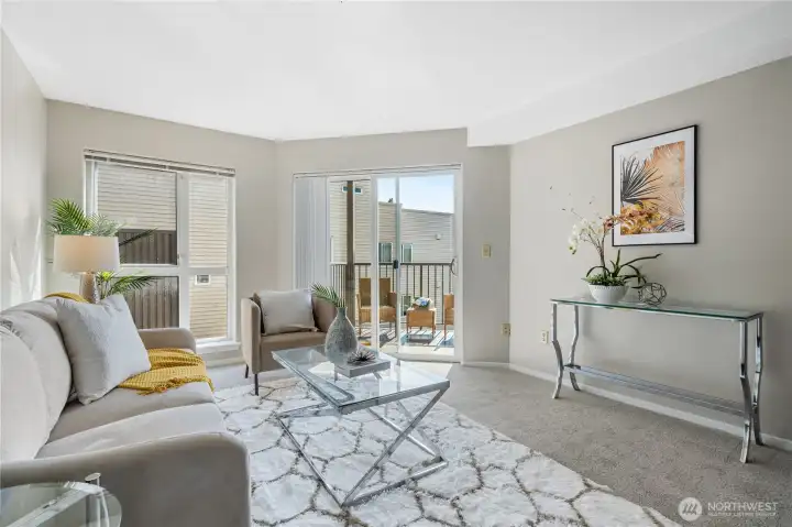 Living room slider leads to private balcony to enjoy morning coffee or evening sunsets