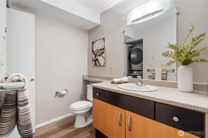 Functional bathroom with built-in laundry area and ample storage to keep essentials organized